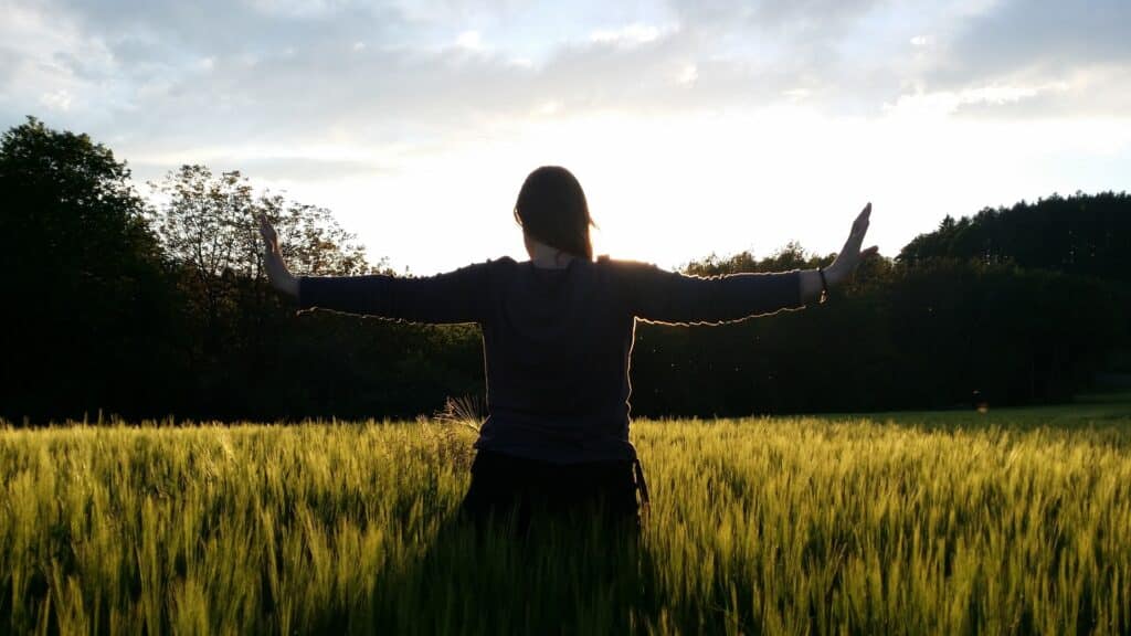 woman in field posing , tai chi movement