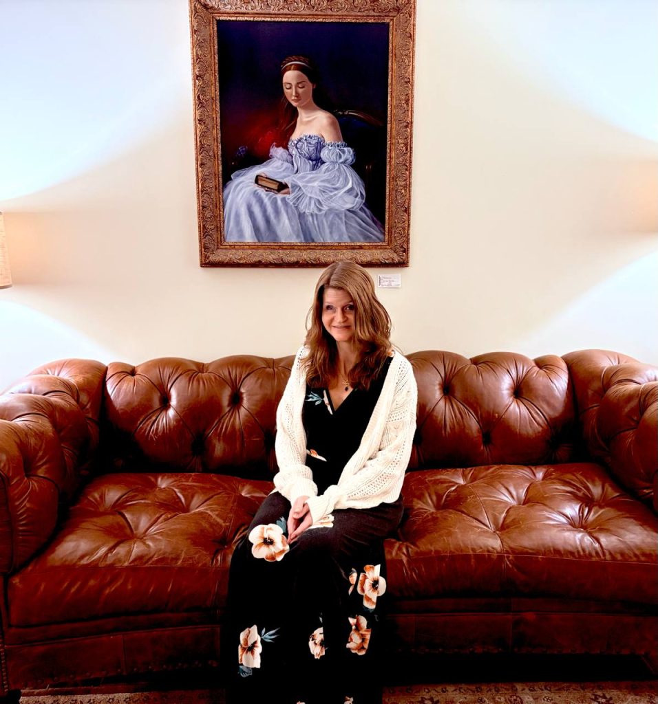 Woman sitting on couch.